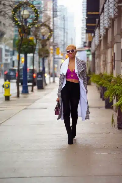 A Fashionable Woman Walking on the Sidewalk