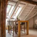 brown wooden dining table with two gray seats near opened window